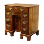 A George II Walnut and Featherbanded Bureau-Table, circa 1740, the crossbanded moulded top above a