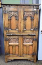 A Titchmarsh & Goodwin Style Oak Cupboard, two carved doors over brushing side, two further doors