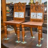 A Pair of Late 19th century Mahogany Hall Chairs, pierced carved backs, each inset with two Minton