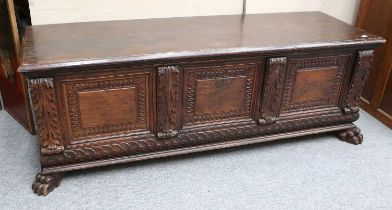 An Oak and Walnut Cassone, panelled front with carved geometric and foliate detail, claw feet, 176cm