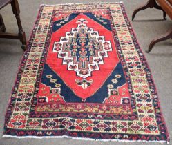 Anatolian Rug, the blood red lozenge field centred by a stepped diamond medallion flanked by
