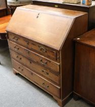 A George III Oak and Mahogany Crossbanded Bureau, the fall flap opening to reveal fitted interior,