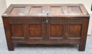 A 17th century and Later Oak Panelled Coffer, of small proportions with iron lock, carved frieze,