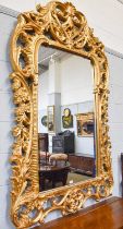 A Large Modern Giltwood Wall Mirror, in the 18th century style, pierced foliate scroll frame,