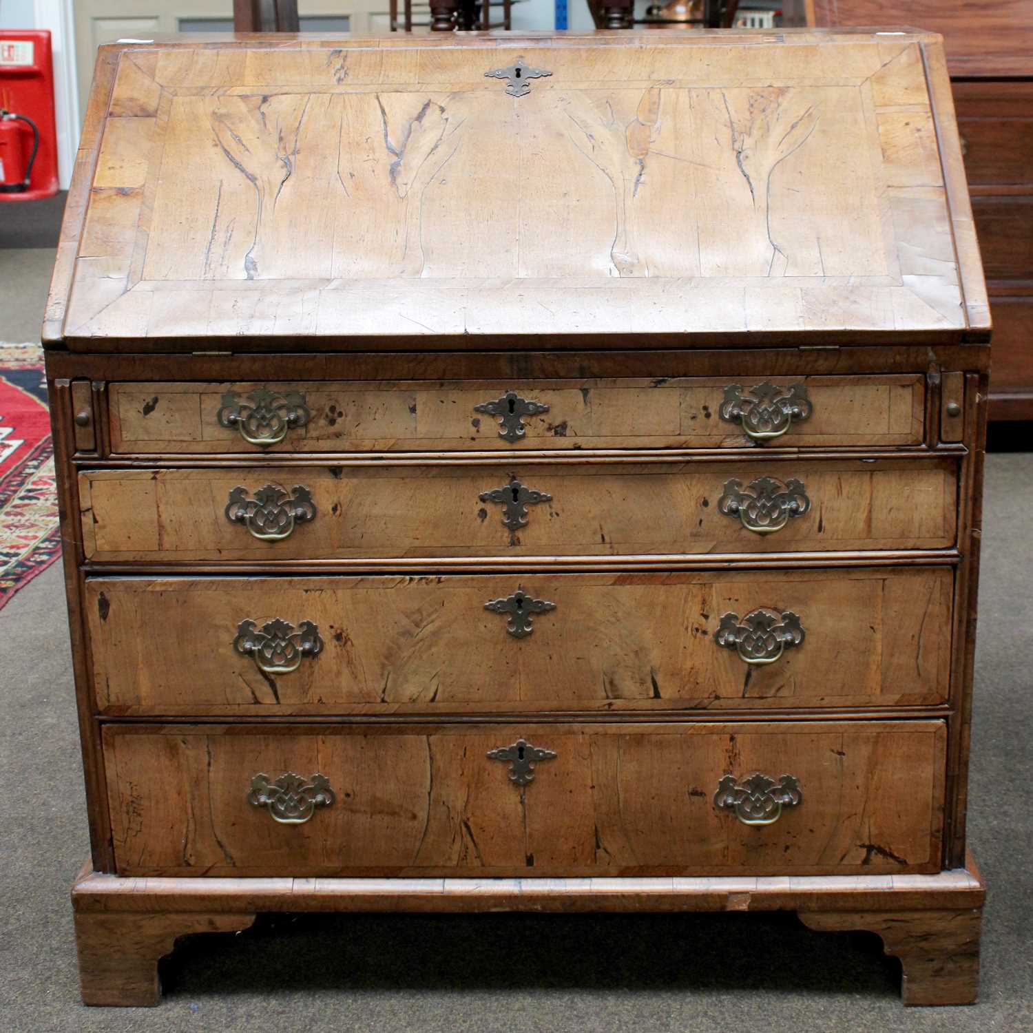 An 18th century Walnut and Crossbanded Bureau, the fall flap opening to reveal fitted interior