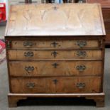 An 18th century Walnut and Crossbanded Bureau, the fall flap opening to reveal fitted interior