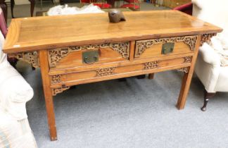 A Chinese Hardwood Side Table, fitted with two drawers, carved stylised decoration,raised on
