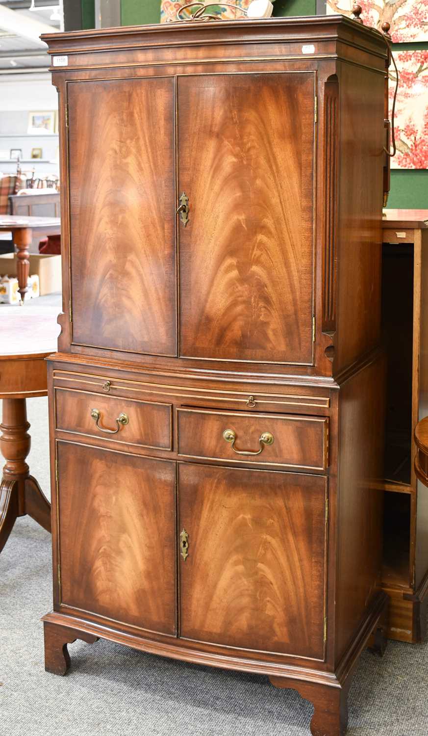 A Reproduction Georgian Style Flame Mahogany Drinks Cabinet, twin cupboard doors with mirrored