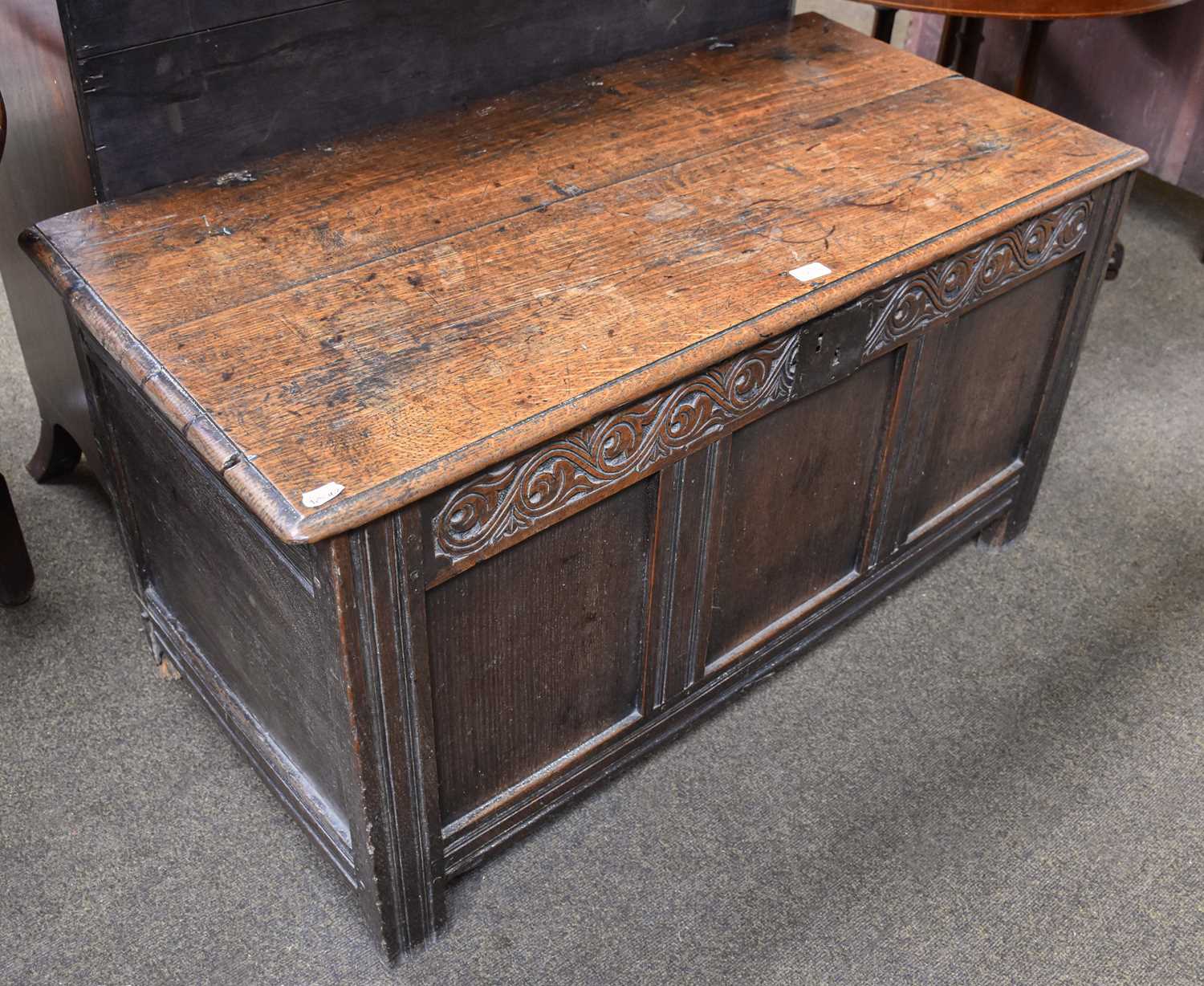 A Late 17th Century Oak Coffer, with hinged lid, carved foliate scroll frieze, on stile ends, 63cm