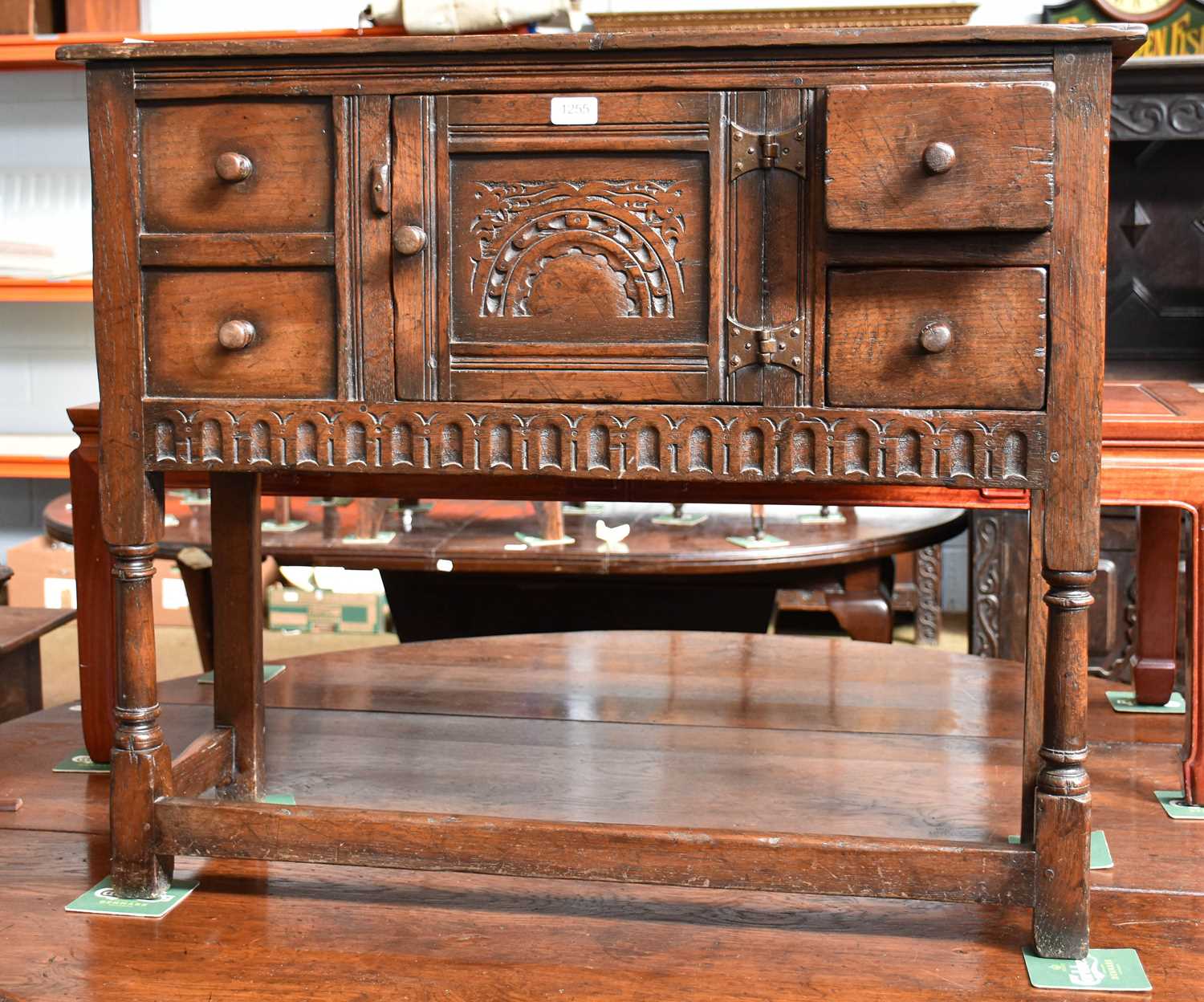 A Titchmarsh and Goodwin Style Carved Oak Cabinet of small proportions, central cupboard, flanked by