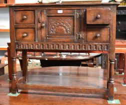 A Titchmarsh and Goodwin Style Carved Oak Cabinet of small proportions, central cupboard, flanked by
