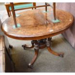 A Victorian Walnut and Inlaid Centre Table, of oval form, raised on four reeded columns to