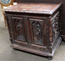 A Carved Oak Chest, some earlier timbers, with hinged lid, elaborate figural panels to the front and