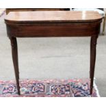 An Early 19th century Mahogany Fold Over Tea Table, raised on slender turned legs, 75cm by 86cm by