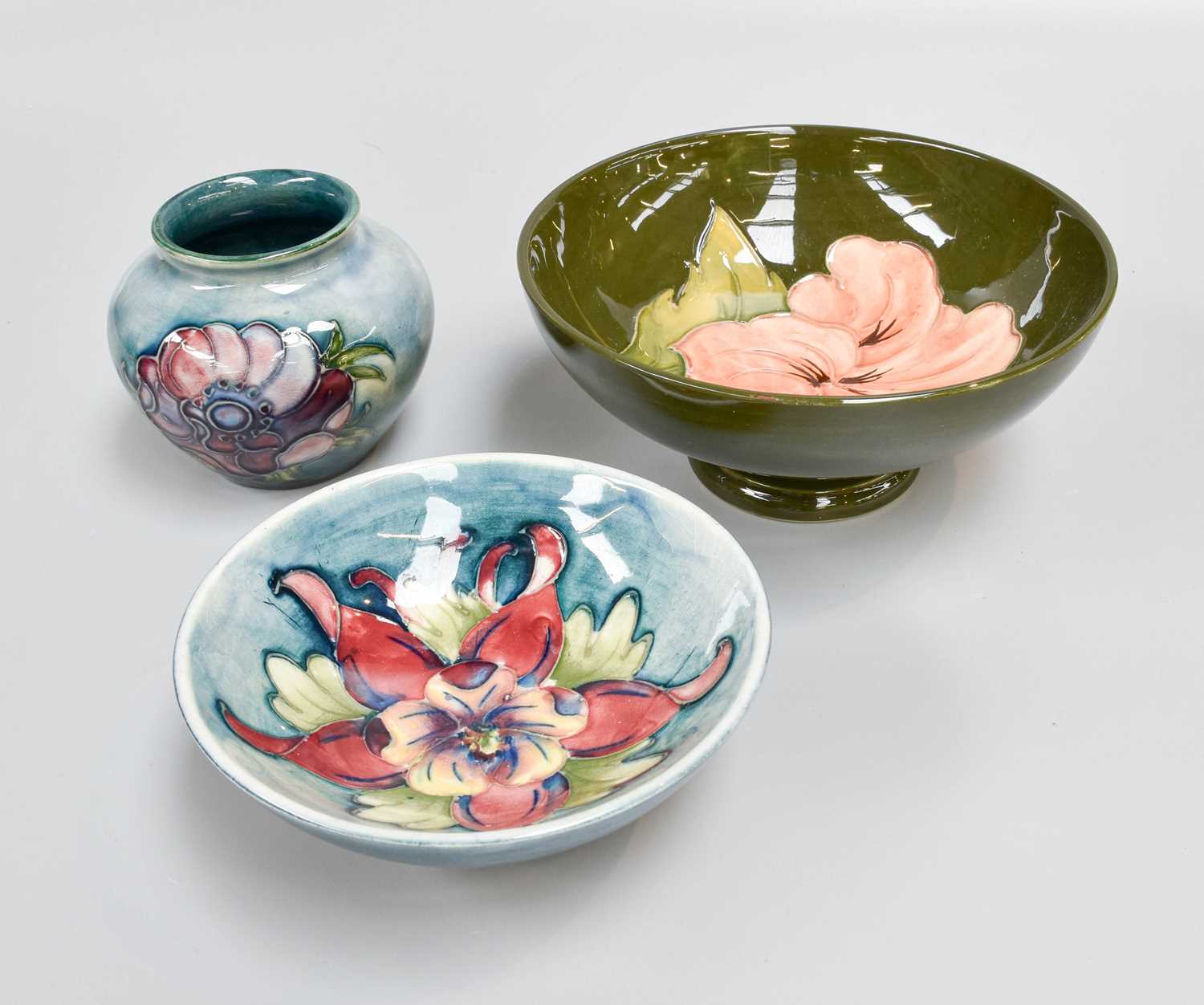 Three Moorcroft Pieces Comprising, Hibiscus footed bowl, Anemone vase and an Orchid dish, largest