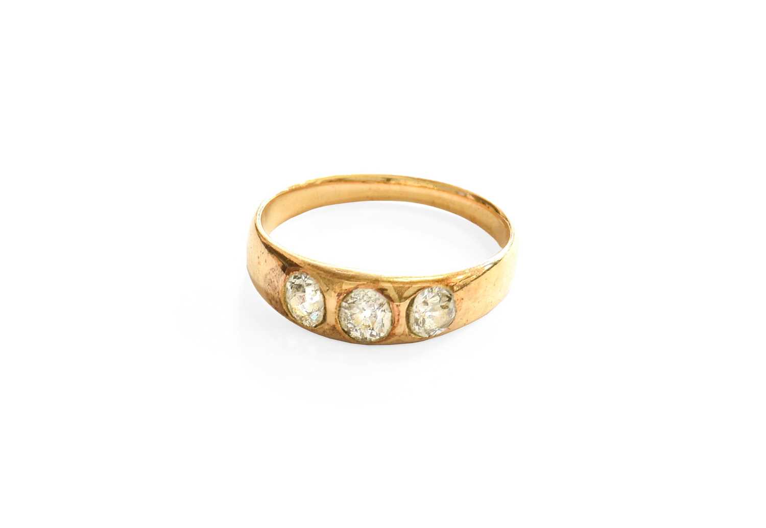 A Late Victorian Diamond Three Stone Ring, the old cut diamonds inset within a yellow plain polished