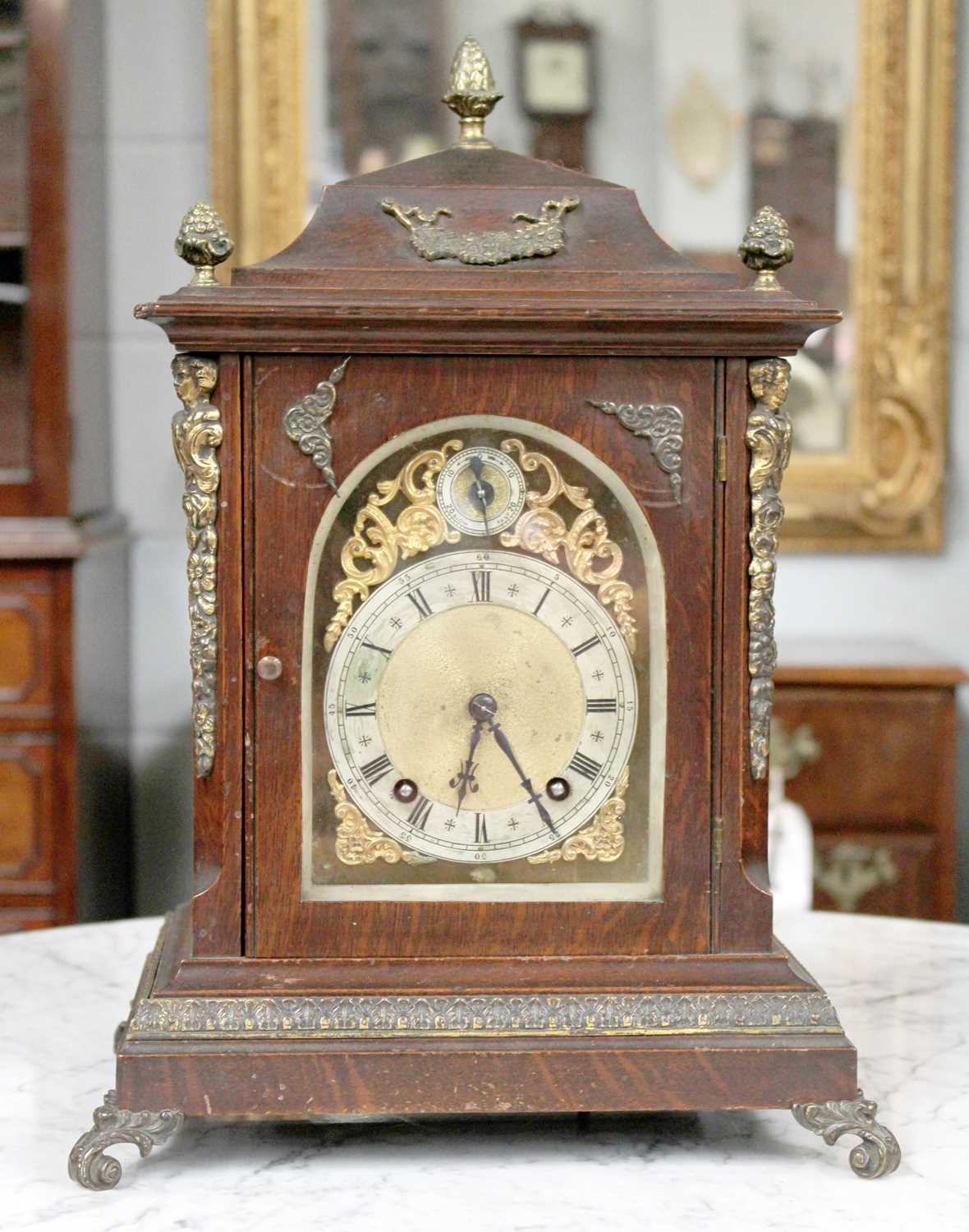 An Oak Cased Table Clock, twin train eight day movement, arched Roman dial, gilt mount, 42cm high