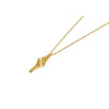 An 18 Carat Gold Diamond Pendant on Chain, three round brilliant cut diamonds in a yellow plain