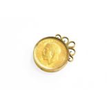 A Sovereign Charm, dated 1915, enclosed within a perspex cover, mount stamped '18CT', length 3.0cm