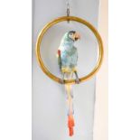 A Continental Porcelain Parrot, on hanging brass ring perch The parrot is 62cm high The perch,