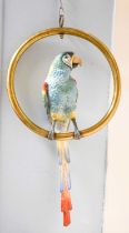 A Continental Porcelain Parrot, on hanging brass ring perch The parrot is 62cm high The perch,