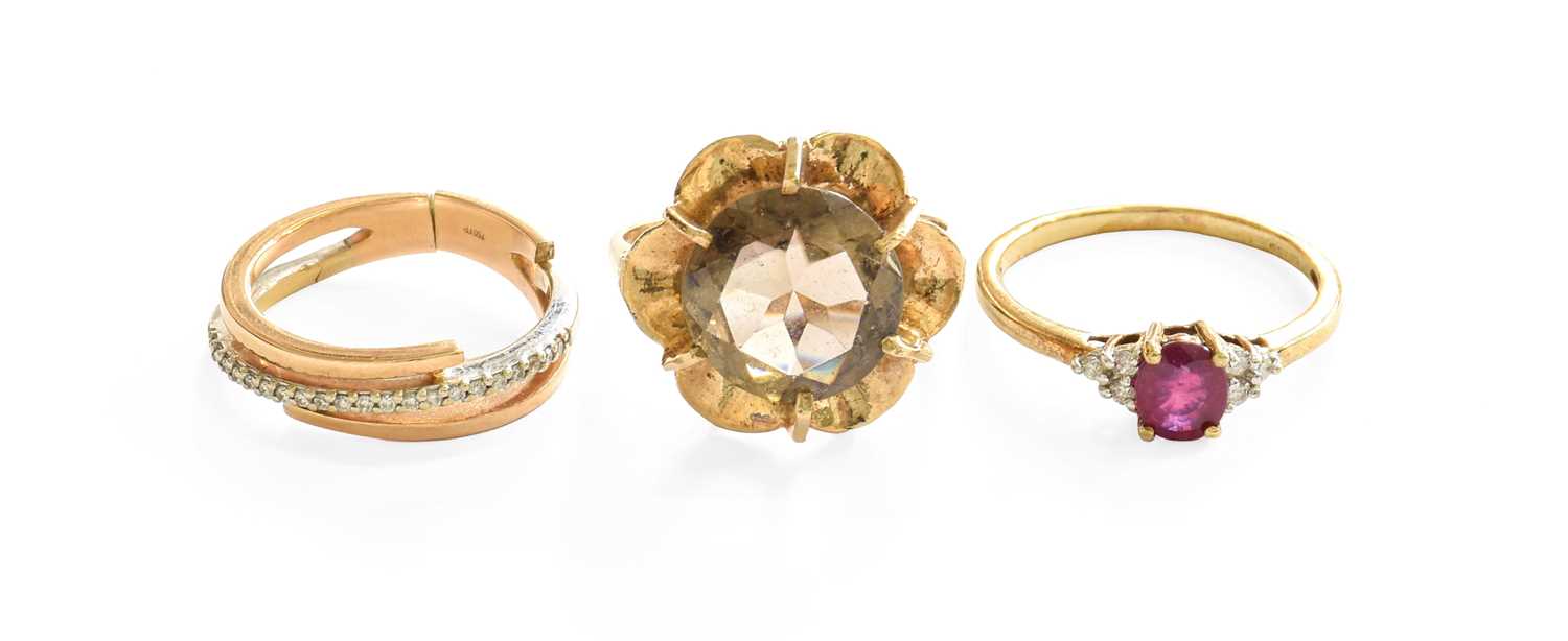 A 9 Carat Gold Smoky Quartz Ring, the round cut smoky quartz in a yellow claw setting, within a