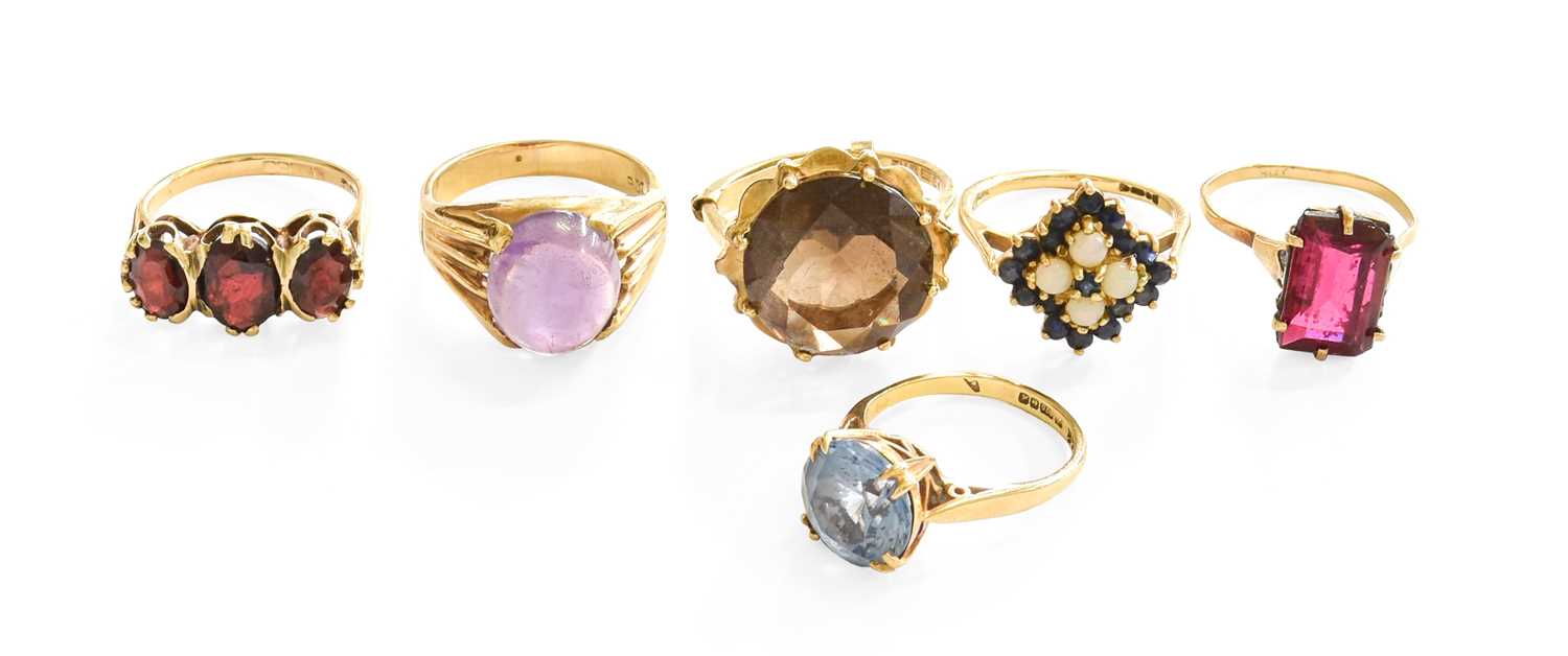 Six Dress Rings, comprising of a cabochon amethyst ring, stamped '9CT', finger size L; a 9 carat