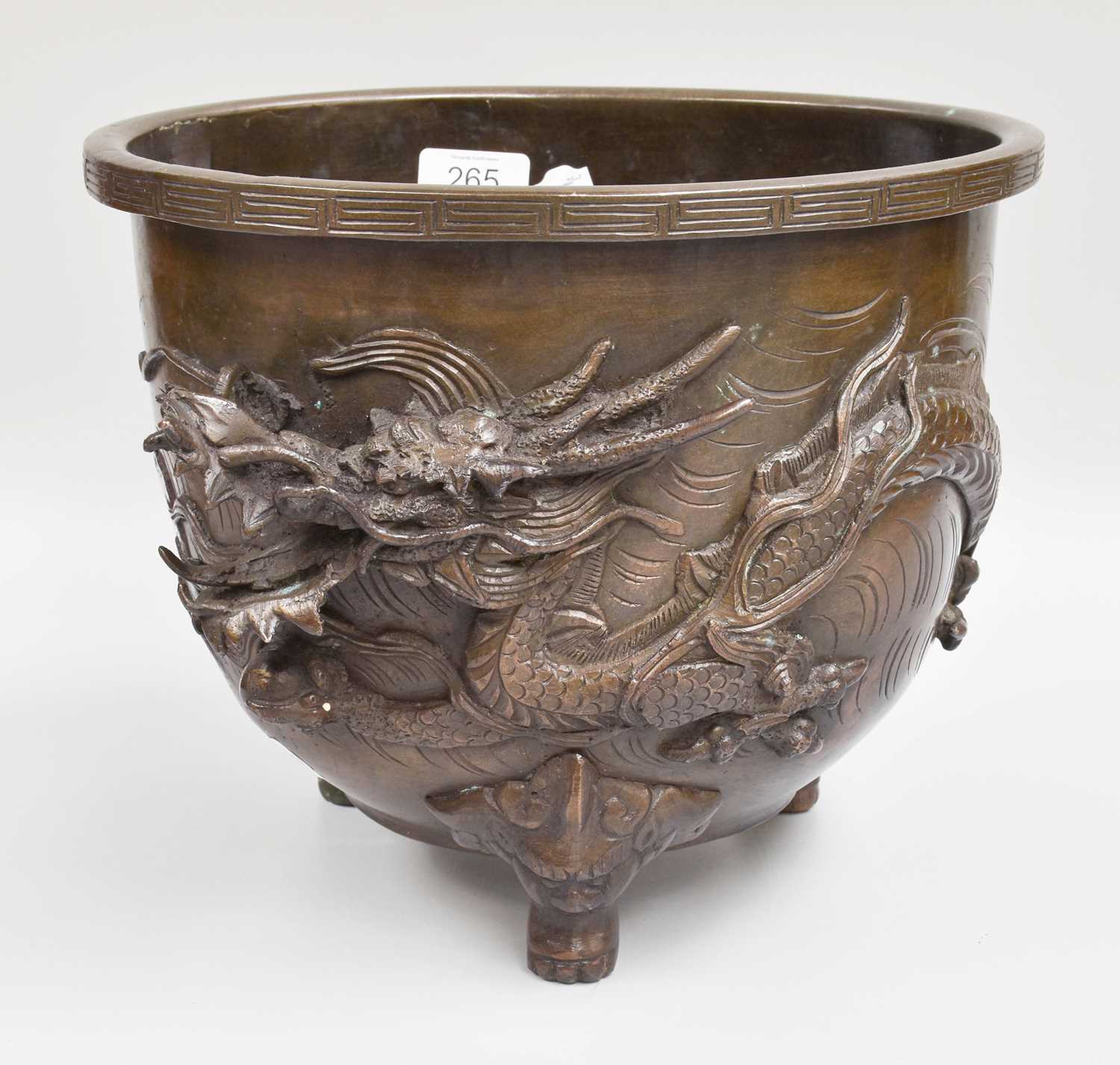 A Japanese Arcaic Style Jardiniere, decorated in high relief with a dragon, 22cm high