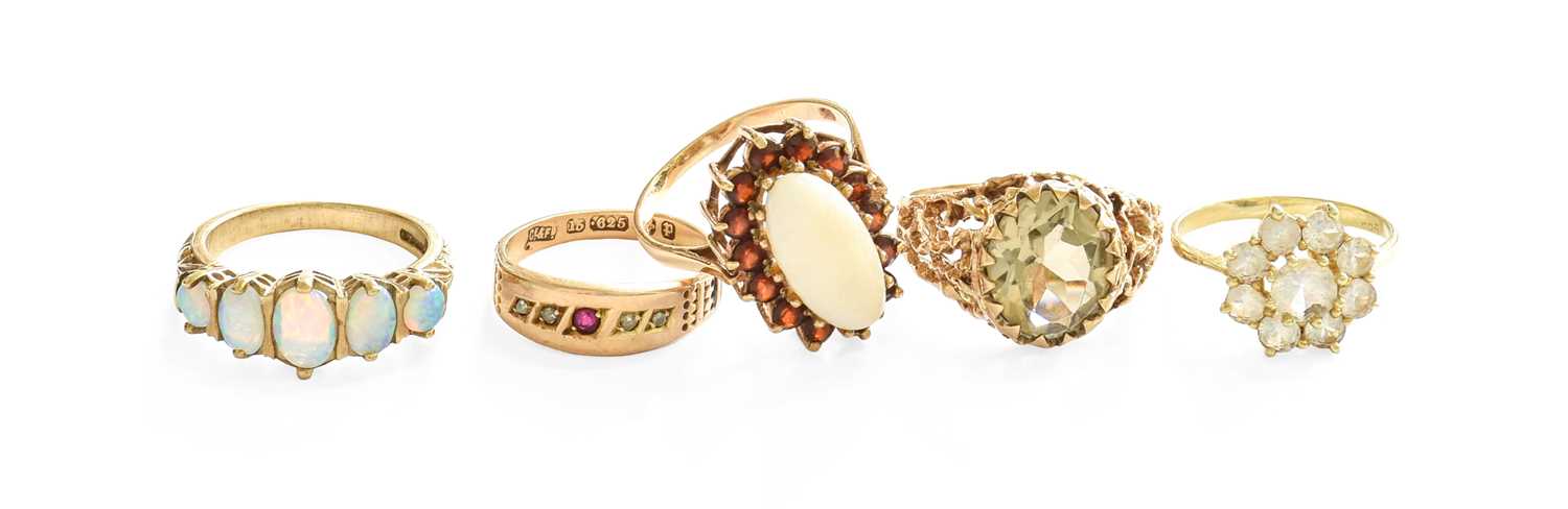 Five Dress Rings, comprising of a 9 carat gold opal and garnet cluster ring, finger size Q; a 9