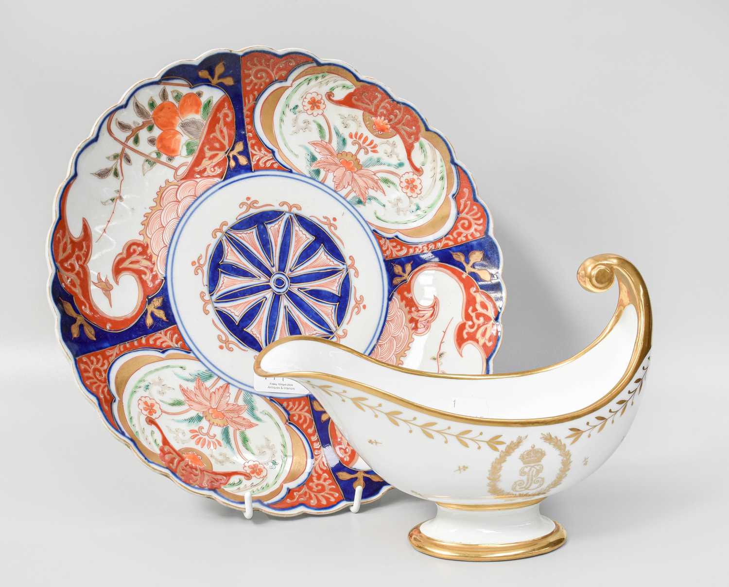 A Sevres Porcelain Sauceboat, of scroll form, embellished in gilt and monogrammed; together with a