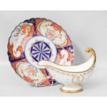 A Sevres Porcelain Sauceboat, of scroll form, embellished in gilt and monogrammed; together with a