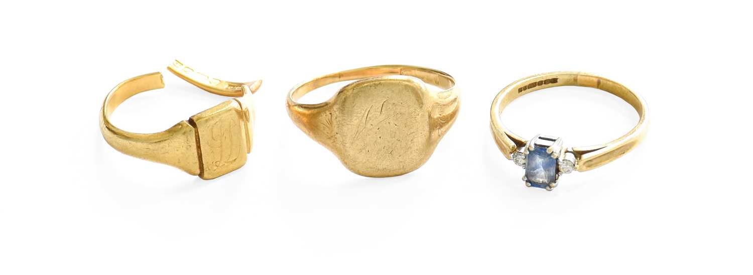 A 9 Carat Gold Signet Ring, finger size T1/2; A 9 Carat Gold Sapphire and Diamond Three Stone