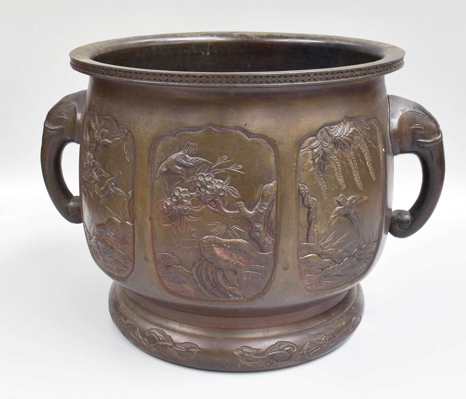 A Japanese Meiji Period Bronze Jardiniere, with twin elephant mask handles, 23cm high