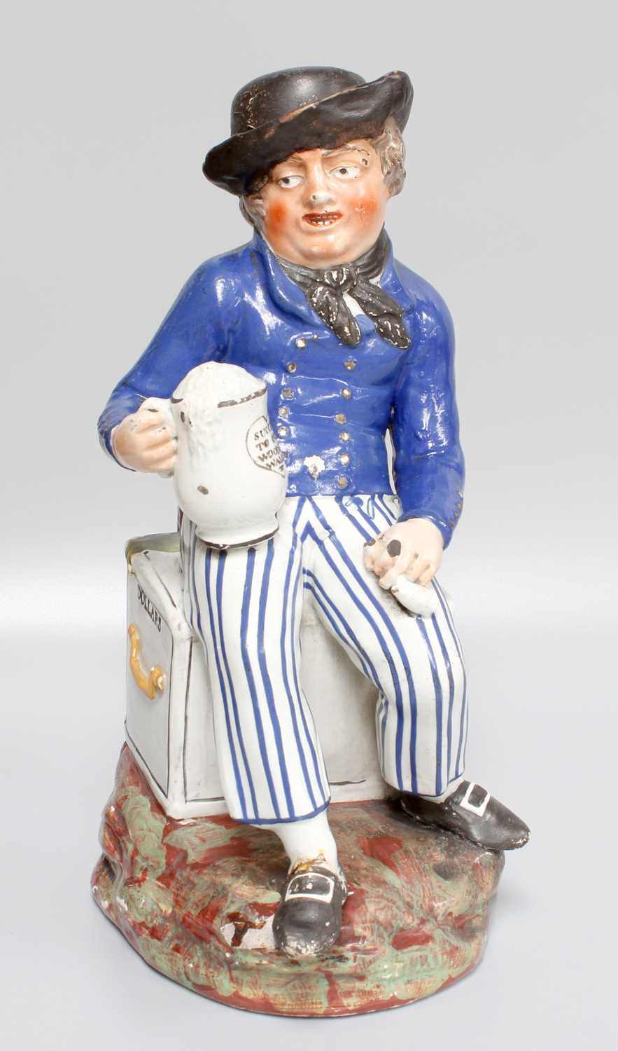 An Early 19th Century Enamel Painted ''Amercan Sailor'' Toby Jug, holding a tankard, inscribed ''