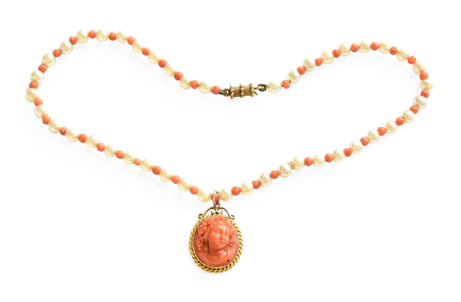 A Coral Pendant on a Coral and Simulated Pearl Necklace, the pendant carved with Bacchus in a yellow