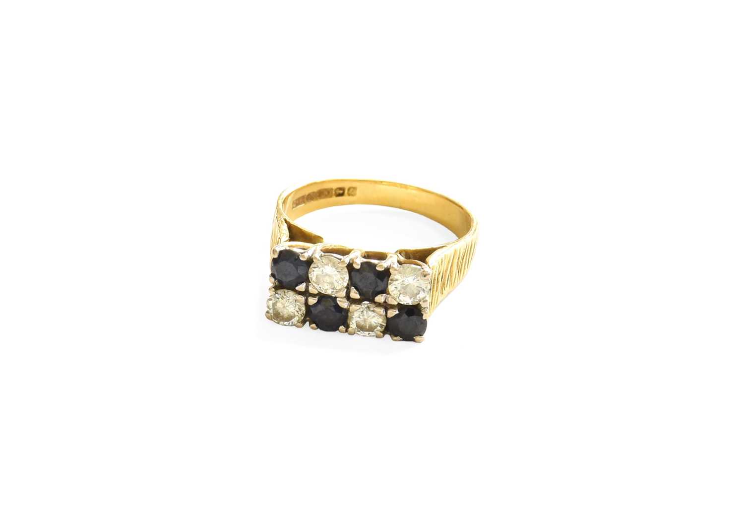 An 18 Carat Gold Sapphire and Diamond Ring, formed of two rows of alternating round brilliant cut