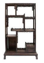 A Chinese Export Carved Hardwood Display Cabinet, early 20th century, the framework carved as a