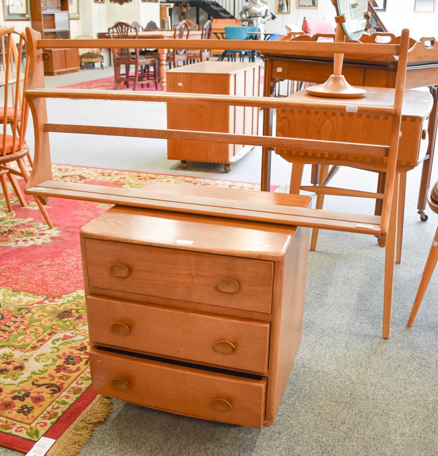 An Ercol Light Elm Bedside Chest of Drawers, 48cm by 45cm by 53cm, together with a two tier plate