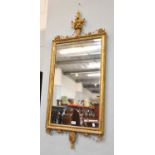 A 19th Century Giltwood Mirror surmounted by an urn, 120cm by 52cm