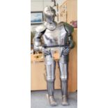 A Modern Reproduction Polished Steel Complete Suit of Armour, on wooden stand 173cm high on its