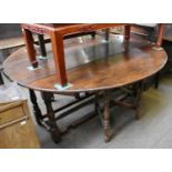 An Oak Double Gateleg Dining Table, in the Titchmarsh & Goodwin Style, oval top, raised on turned