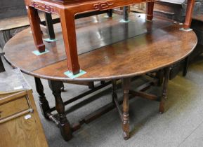 An Oak Double Gateleg Dining Table, in the Titchmarsh & Goodwin Style, oval top, raised on turned