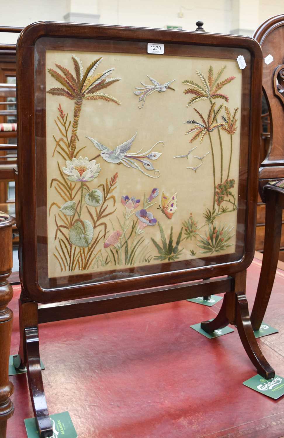 A Mahogany Fire Screen Table, with a silk work panel depicting birds, insects and foliage, 57cm by