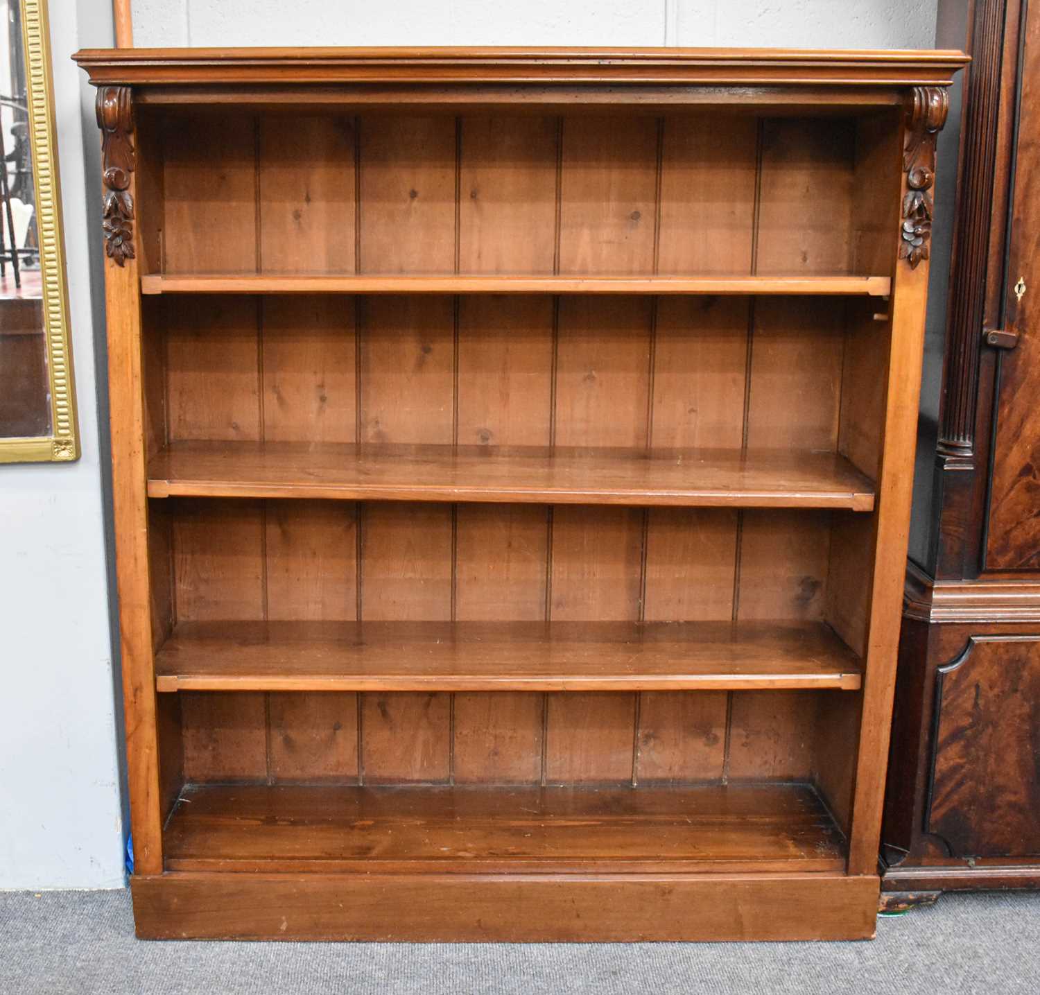 A Crossbanded Mahogany Open Bookcase, with three adjustable shelves, 120cm by 35cm by 133cm