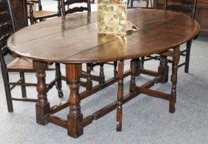 A 19th Century Oak Wake Table, on turned and block supports, 214cm by 150cm by 75cm