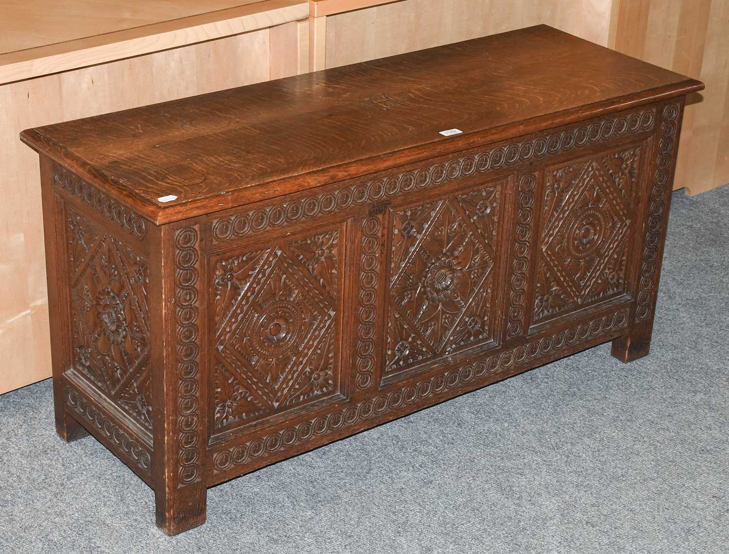 A Early 20th Century Carved Oak Coffer, the top dated 1914 and initialed IWH, 122cm by 45cm by 61cm
