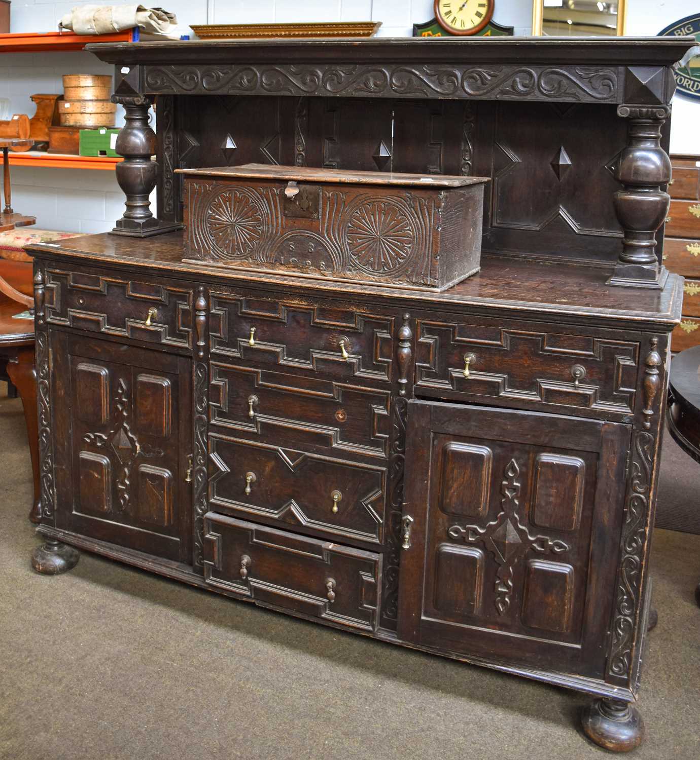 A Jacobean Style Oak Buffet, with geometric carved panels, heavy baluster supports, arrangement of