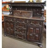 A Jacobean Style Oak Buffet, with geometric carved panels, heavy baluster supports, arrangement of