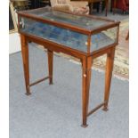 An Early 20th century Display Table, the hinged glazed top on four glazed sides, housing a lined