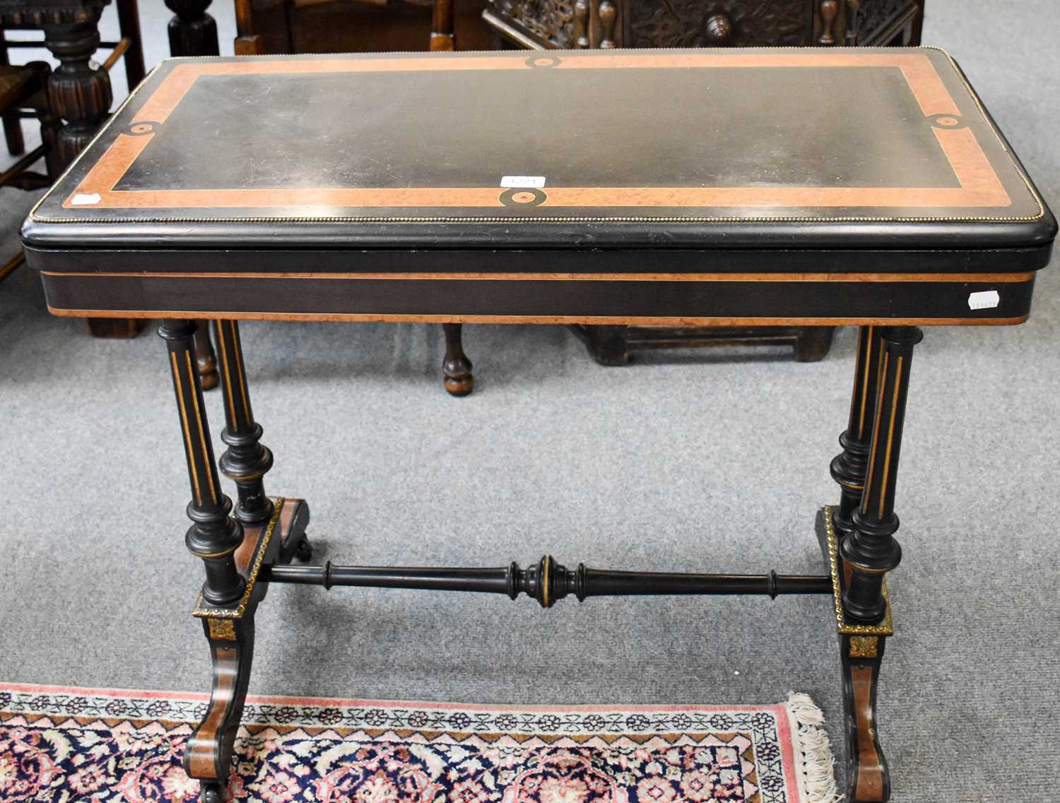 A 19th century Ebony and Amboyna Fold Over Card Table, with gilt metal mounts, 92cm by 46cm by 74cm